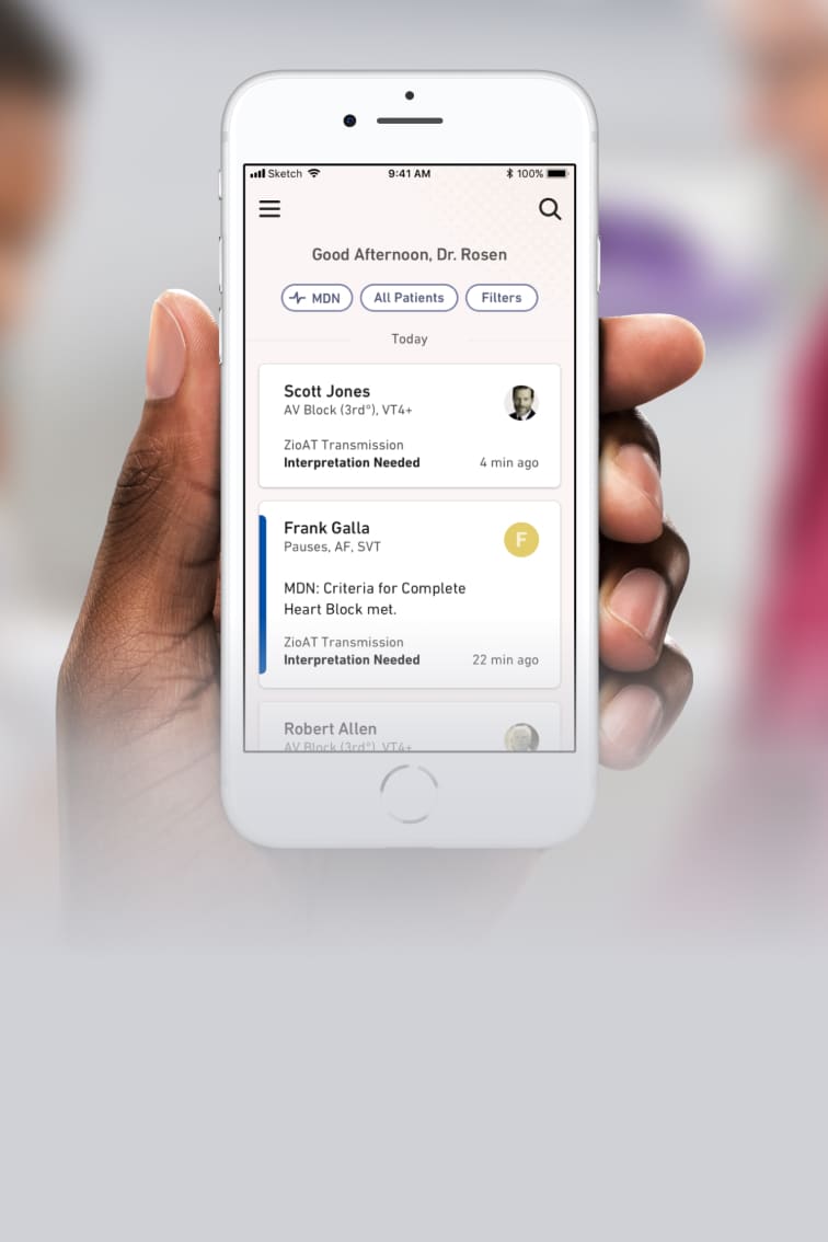 Doctor looking at their smartphone which shows the iRhythm interface and includes a list of patient names
