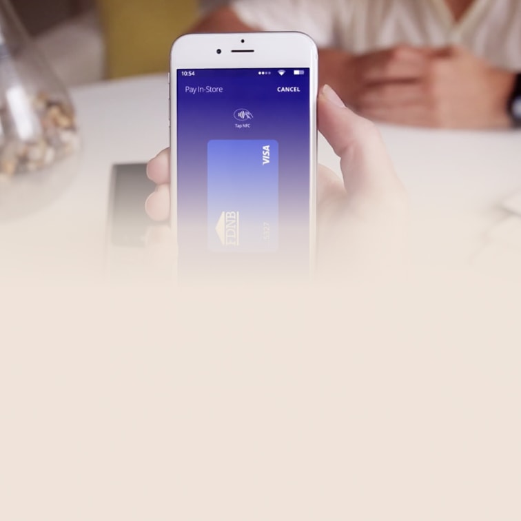 Finance app showing a Visa payment card at a point of sale terminal