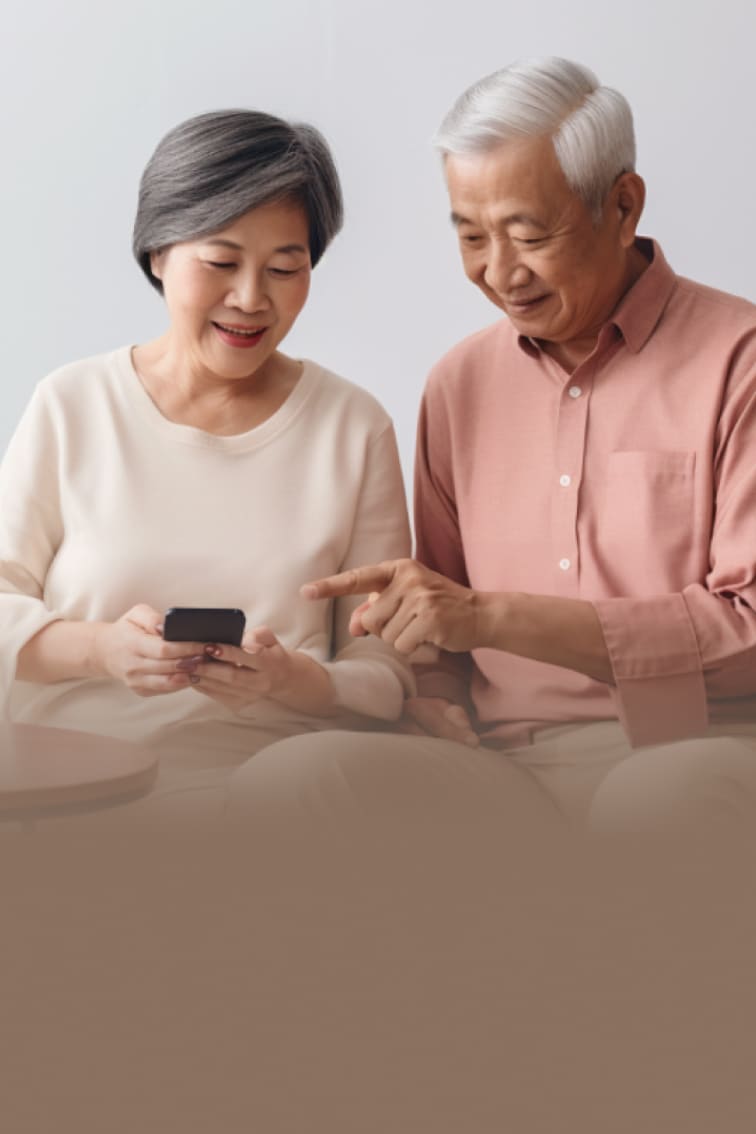 Elderly couple looking at a continuous glucose monitor device