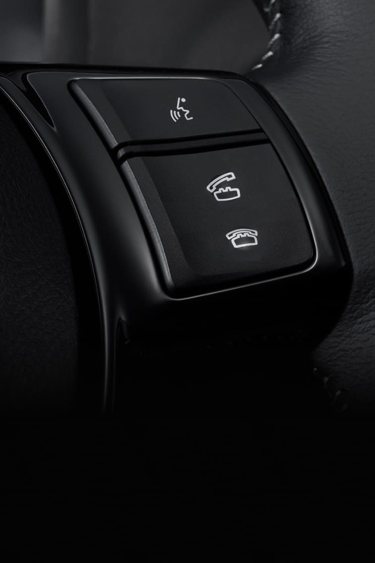 Closeup of Toyota steering wheel voice control buttons
