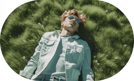 Young person lying in a field of grass