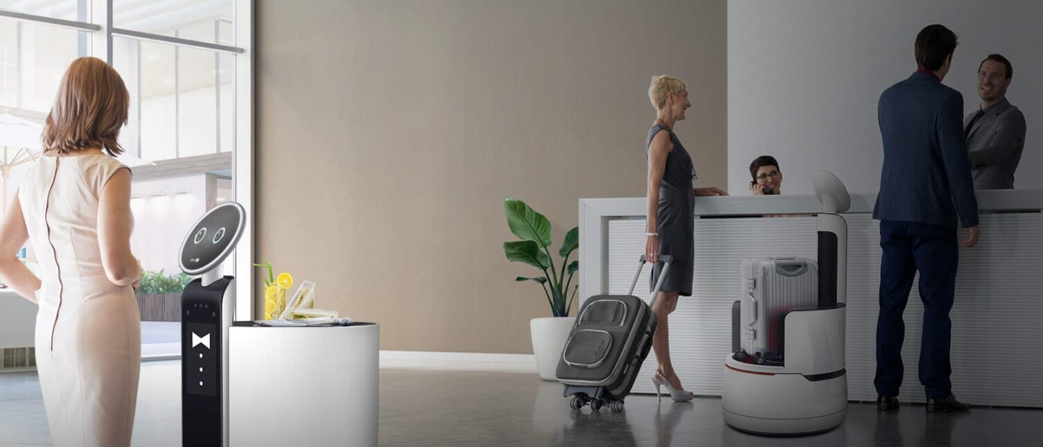 A person interacts with a friendly robotic concierge at an upscale hotel.