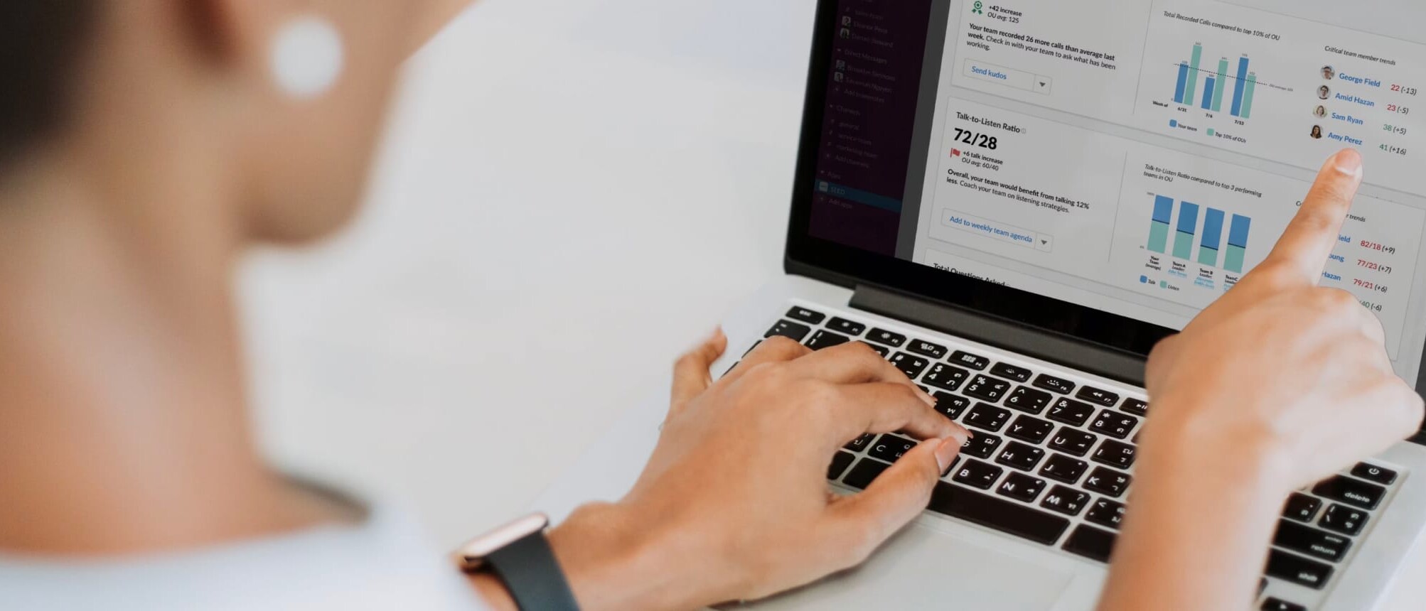 An employee reviews an AI summary of sales metrics on her laptop.